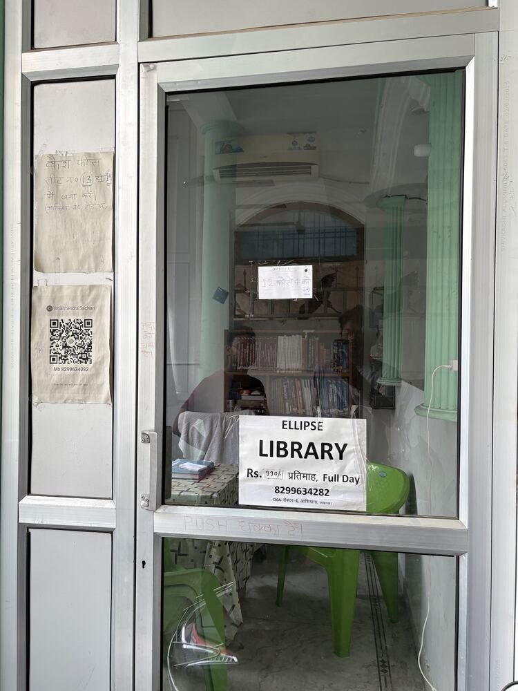 Ellipse Library front door with signage and reading shelf visible inside